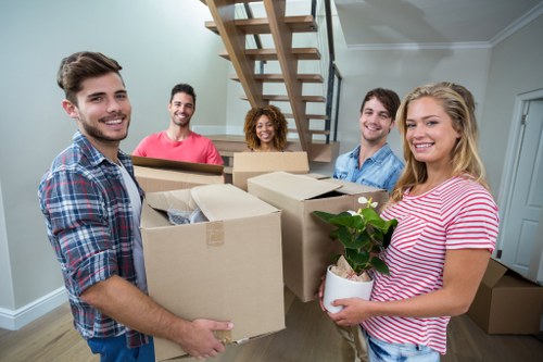 Movers preparing equipment and safety checks before a removal job