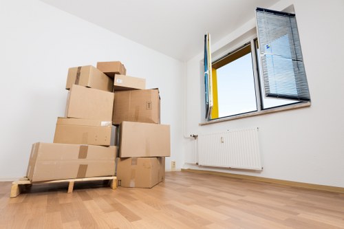 Careful wrapping of fragile household items during a Roehampton packing service