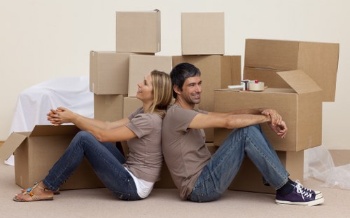 Professional movers in Roehampton protecting furniture during packing