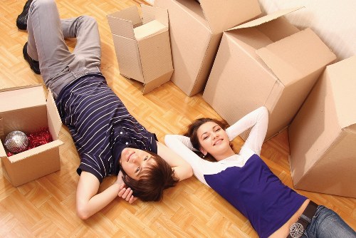 Professional movers handling bulky household furniture in Roehampton flat access